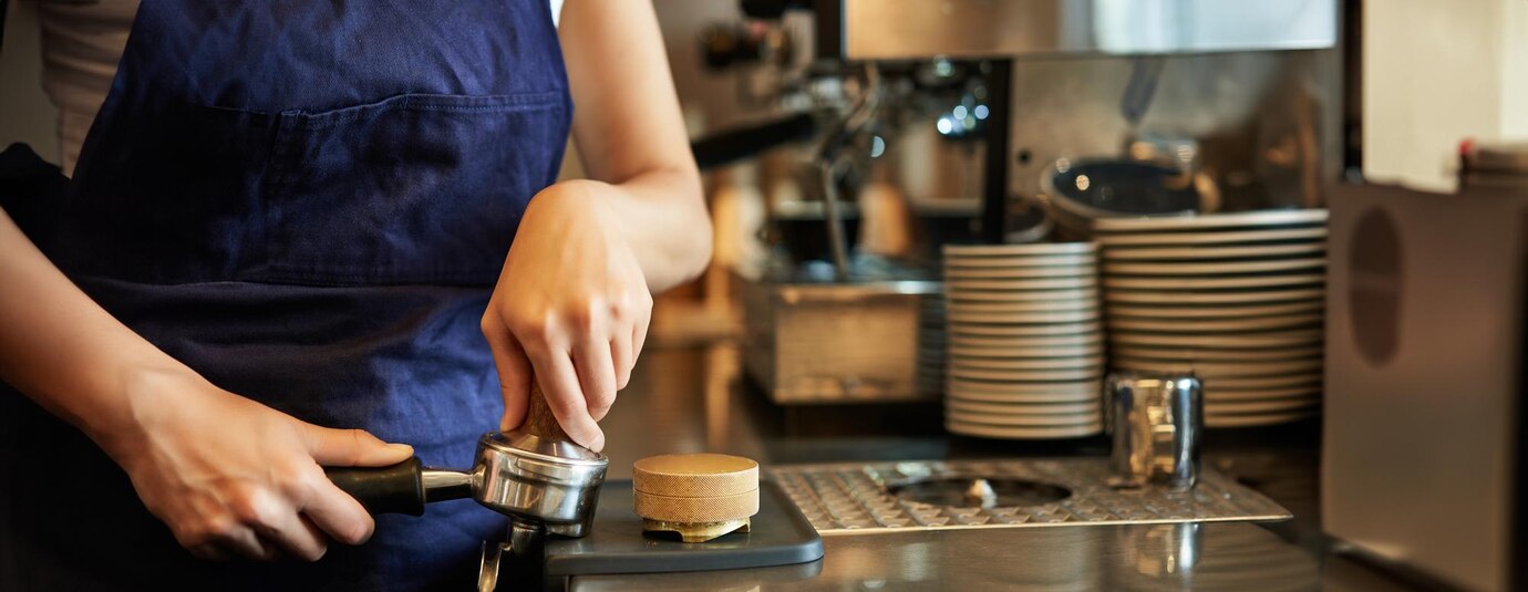 close-up-barista-female-hands-pressing-coffee-into-tamper-prepares-order-cafe-counter_1258-203403.jpg