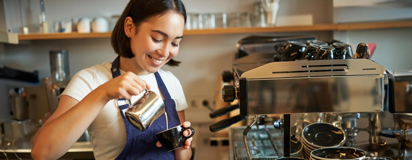 close-up-cute-asian-barista-girl-making-cappuccino-doing-latte-art-cup-with-steamed-milk_1258-203384.jpg